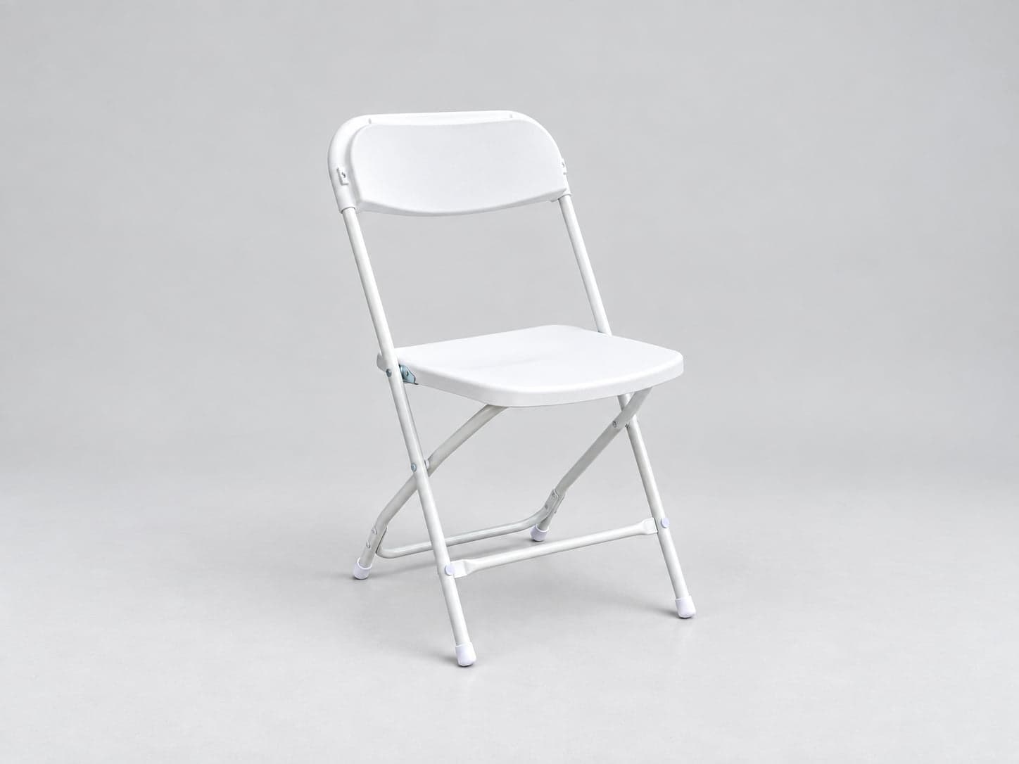 Trillium's white folding chair, photographed against a plain studio background